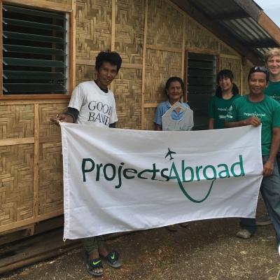 Students participating in construction volunteering in the Phillipines to help build much needed sanitation block Projects Abroad volunteers take part in building volunteer work in the Phillippines to help construct water sanitation building